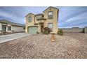 Two-story home with stucco exterior, green garage door, and desert landscaping at 703 N Redwood Ln, Buckeye, AZ 85326