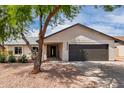 Inviting single-story home featuring a well-maintained yard and a two car garage at 7232 W Sunnyside Dr, Peoria, AZ 85345