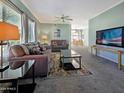 Comfortable living room with a large window, gray carpet, and TV at 750 E Northern Ave # 2088, Phoenix, AZ 85020