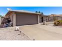 Exterior of home with a gray garage door with a long driveway and desert landscaping at 7904 E Madero Ave, Mesa, AZ 85209