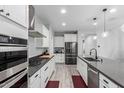 Modern kitchen featuring stainless steel appliances, gray countertops and white cabinetry at 8737 E Nichols Ave, Mesa, AZ 85209