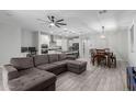 Spacious open-concept living space featuring a modern kitchen, a dining area, and a comfortable living room at 8737 E Nichols Ave, Mesa, AZ 85209
