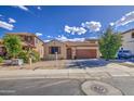 Inviting single-story home featuring a two-car garage, desert landscaping, and a cozy front porch at 9413 W Williams St, Tolleson, AZ 85353