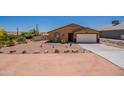 Single story home boasting desert landscaping, rocks, and a large driveway leading to a two-car garage at 10177 E La Palma Ave, Gold Canyon, AZ 85118