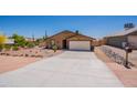 Single story home with desert landscaping, concrete driveway, and direct access to a two-car garage at 10177 E La Palma Ave, Gold Canyon, AZ 85118