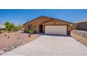 Charming single story home with an attached two car garage, desert landscaping, and tiled roof at 10177 E La Palma Ave, Gold Canyon, AZ 85118