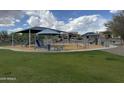 Community playground features swings, slides, and shade structures for Gathering fun at 10736 W Swayback Pass, Peoria, AZ 85383