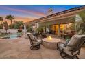 Inviting backyard featuring a pool, covered patio, and a cozy fire pit surrounded by comfortable seating at 10907 E Bella Vista Dr, Scottsdale, AZ 85259
