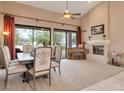 Spacious dining room with large windows, a fireplace, and access to the outdoor patio at 10907 E Bella Vista Dr, Scottsdale, AZ 85259