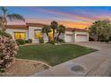 Charming single-story home boasting a well-manicured lawn, a three-car garage, and a tile roof at 10907 E Bella Vista Dr, Scottsdale, AZ 85259