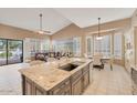 Open-concept kitchen with granite island, modern appliances, and a breakfast nook at 10907 E Bella Vista Dr, Scottsdale, AZ 85259