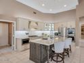 Modern kitchen with stainless steel appliances, a large island, and custom cabinetry at 10907 E Bella Vista Dr, Scottsdale, AZ 85259