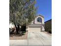 Charming two-story home featuring a two-car garage and well-maintained front yard landscaping at 11460 W Eden Mckenzie Dr, Surprise, AZ 85378
