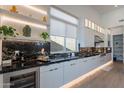 Open kitchen featuring black marble countertops and backsplash, stainless steel appliances, and bright, modern lighting at 14141 E Highland Ave, Fountain Hills, AZ 85268