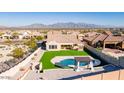 This aerial view showcases a private backyard with pool, pergola, and lush artificial turf at 14552 S 182Nd Dr, Goodyear, AZ 85338
