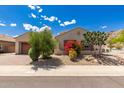 Charming single-story home with desert landscaping and a brick-paved driveway at 14552 S 182Nd Dr, Goodyear, AZ 85338