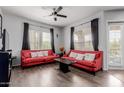 Bright living room with stylish wood floors, two couches and lots of light from the large window at 14575 W Mountain View Blvd # 11220, Surprise, AZ 85374