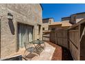 Private back patio with brick pavers, seating area, and a wood fence at 15407 N 2Nd St, Phoenix, AZ 85022