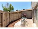 Private back patio with brick pavers, wooden fence, grill, and outdoor seating at 15407 N 2Nd St, Phoenix, AZ 85022