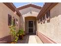 Inviting entryway featuring beautiful plants, desert landscaping, and textured exterior walls at 18072 W Paradise Ln, Surprise, AZ 85388