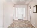 Bright foyer with tile flooring, neutral walls, and a welcoming front door at 18072 W Paradise Ln, Surprise, AZ 85388