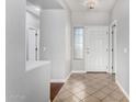 Bright foyer with neutral walls, tile floors, and an accent wall at 18775 E Seagull Dr, Queen Creek, AZ 85142