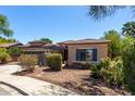 Inviting front yard featuring desert landscaping and a charming covered entry with stone accents at 18775 E Seagull Dr, Queen Creek, AZ 85142