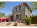 Beautiful two-story home showcasing stone accents, a covered porch, and desert-style landscaping at 20045 N 49Th Dr, Glendale, AZ 85308