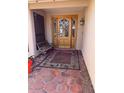 Inviting covered front porch with decorative wood door, vintage-style bench, and vintage-style area rug at 2022 Leisure World --, Mesa, AZ 85206