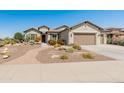 Attractive single-story home with desert landscaping, paved walkway, and a two-car garage at 20506 N 271St Ave, Buckeye, AZ 85396