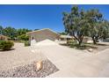 Attractive single-story home with low maintenance desert landscaping and a long driveway at 21218 N Aurora Dr, Sun City West, AZ 85375