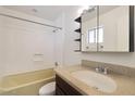 Bathroom featuring tub/shower combo, single sink vanity, and medicine cabinet at 233 E Cairo Dr, Tempe, AZ 85282