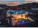Aerial view of a home with a backyard pool, spa, fire pit, and patio area for entertaining at 2609 W Lavitt Ln, Phoenix, AZ 85086