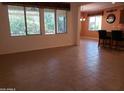 Open-concept living area with neutral tile flooring and large windows with decorative valances at 2611 E San Paulo Dr, Casa Grande, AZ 85194