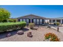 Cozy home with neat desert landscaping, trimmed shrubs, and a covered parking area at 2807 W Gregory St, Apache Junction, AZ 85120
