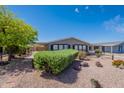 Charming home with tidy front yard, gravel landscaping and covered parking at 2807 W Gregory St, Apache Junction, AZ 85120