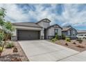 Inviting home features a spacious driveway and low maintenance landscaping, providing ample curb appeal at 2923 W Shanley Ave, Apache Junction, AZ 85120