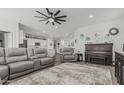 Relaxing living room with gray couches, a large ceiling fan, and wood-look tile flooring at 2923 W Shanley Ave, Apache Junction, AZ 85120
