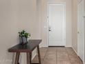 Bright entryway featuring tile flooring, neutral wall paint, and a decorative console table at 3022 W Redwood Ln, Phoenix, AZ 85045