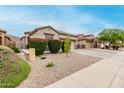 Charming desert home showcasing a well-maintained front yard, a two-car garage, and a neutral color palette at 3022 W Redwood Ln, Phoenix, AZ 85045