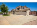 A beautiful home with a long driveway and mature landscaping with plenty of parking at 34949 N Spur Cir, San Tan Valley, AZ 85144