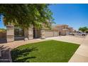 A lovely home with a well manicured lawn and a large three-car garage provides ample parking and storage at 34949 N Spur Cir, San Tan Valley, AZ 85144