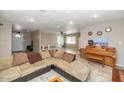 Spacious living room with tile flooring, a large couch, and an open layout perfect for entertaining guests at 4813 W Belmont Ave, Glendale, AZ 85301