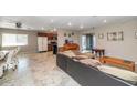 Open-concept living area with tile floors, seamlessly connecting the living, dining, and kitchen spaces at 4813 W Belmont Ave, Glendale, AZ 85301