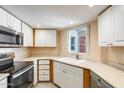 Efficient kitchen with white cabinets, stainless steel appliances, and ample counter space at 4850 E Desert Cove Ave # 240, Scottsdale, AZ 85254