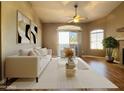 Comfortable living room features a cozy chair, modern sofa, and sliding glass door to the patio at 5335 E Shea Blvd # 2045, Scottsdale, AZ 85254