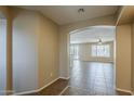 Inviting hallway with tile flooring, archway to living area, creating a warm and welcoming ambiance at 5926 W Questa Dr, Glendale, AZ 85310
