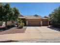 Inviting single-story home with a tile roof, desert landscaping, and a spacious two-car garage at 6135 E Aire Libre Ln, Scottsdale, AZ 85254