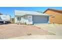 Charming single-story home with a gray and white exterior, a two-car garage, and a well-kept yard at 6826 S 16Th Way, Phoenix, AZ 85042