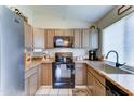 Well-equipped kitchen featuring wooden cabinets, black appliances, and a sleek countertop at 6826 S 16Th Way, Phoenix, AZ 85042